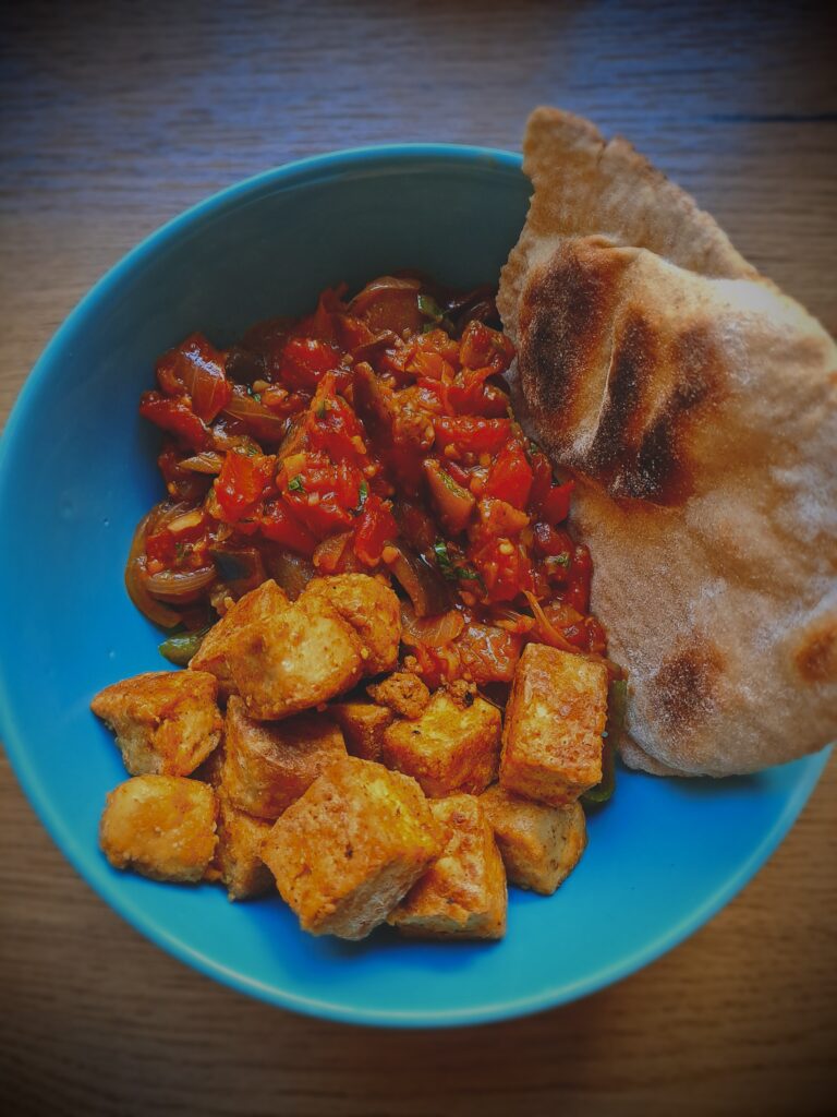 Aubergines with tomatoes, crispy tofu and flatbread